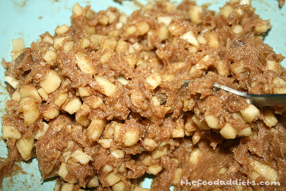 Meanwhile, combine 1 cup brown sugar, 1/2 cup butter, and 2 tsp cinnamon. Then add chopped apple pieces to the mixture. 