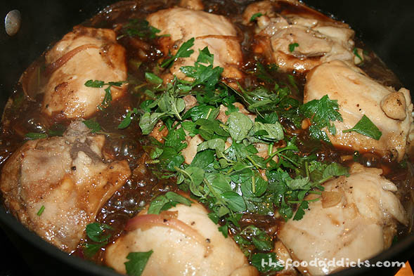 Next, pour in 1/2 cup of soy sauce and 1 cup of vinegar, as well as some chopped parsley, oregano, and a 2-3 bay leaves. Cover the pot and let it simmer for about 20 minutes to let the chicken cook evenly through. 