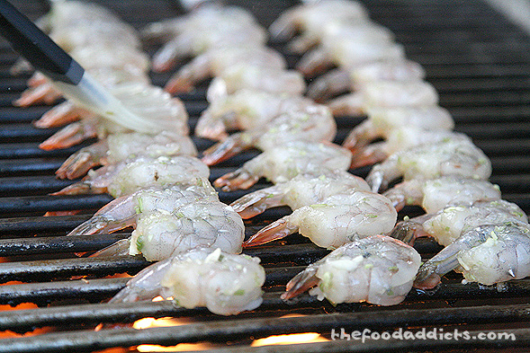 Once the shrimp is ready, place them on the grill and fire it up. My perfectly uniformed army of shrimp only takes a few minutes to cook on each side. Baste the marinade on top to get more flavor. 